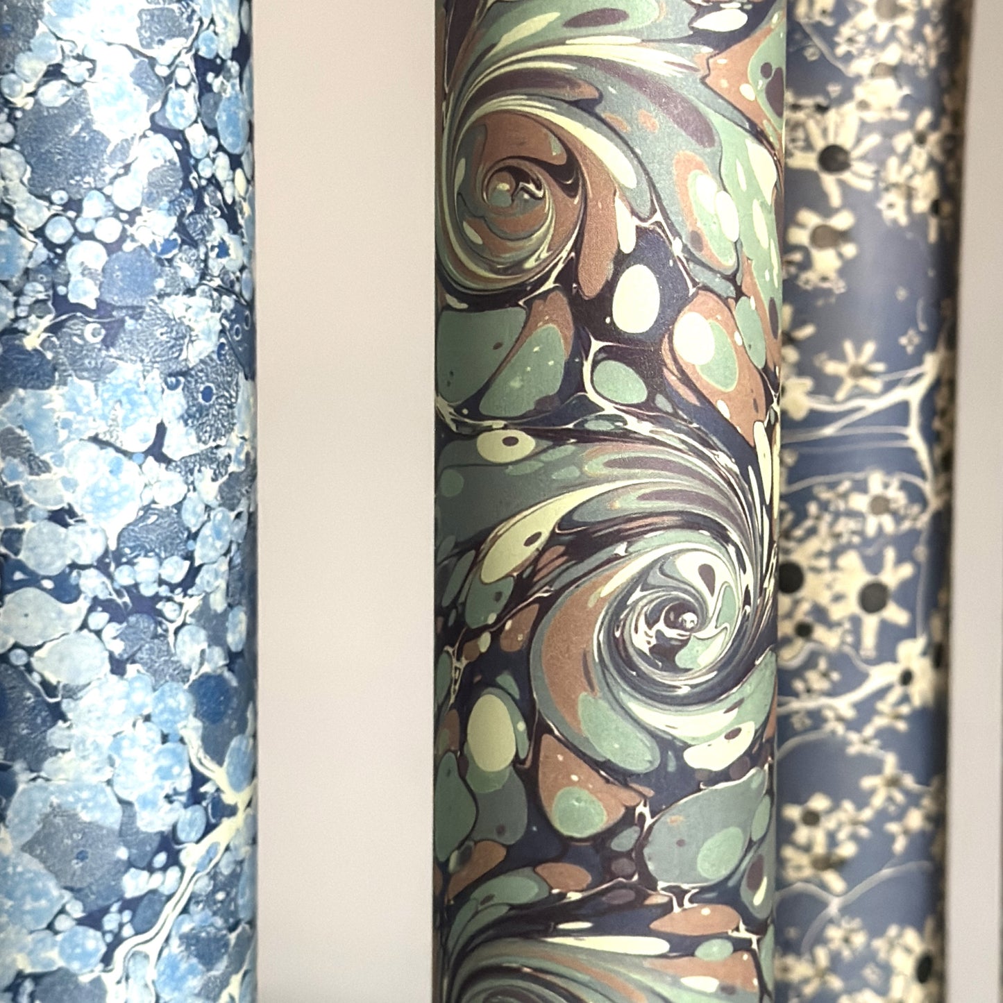 printed marble design wrapping paper by Jemma Lewis. Swirl design in inky greys and lichen greens., close up