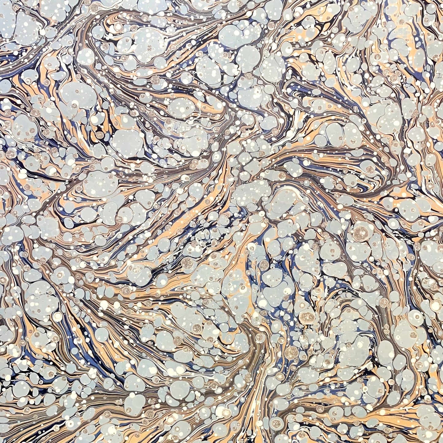 Printed marbled wrapping paper by Jemma Lewis Marbling. Marbled paper in earth tones of brown, sand, grey and soft blue
