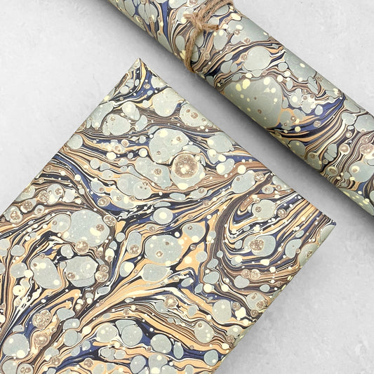 Printed marbled wrapping paper by Jemma Lewis Marbling. Marbled paper in earth tones of brown, sand, grey and soft blue