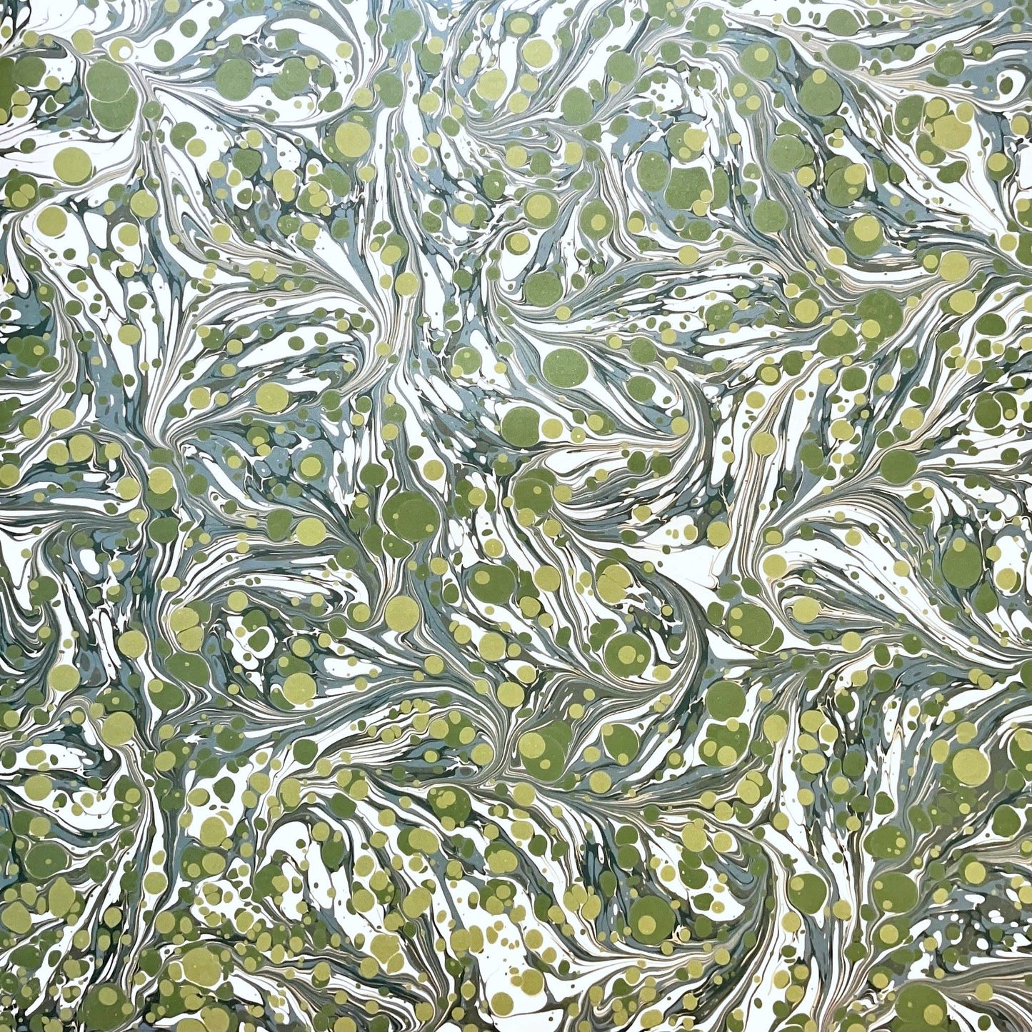 Printed marbled wrapping paper by Jemma Lewis Marbling. Marbled paper with a shimmery base paper and marbled pattern in green, lime and white