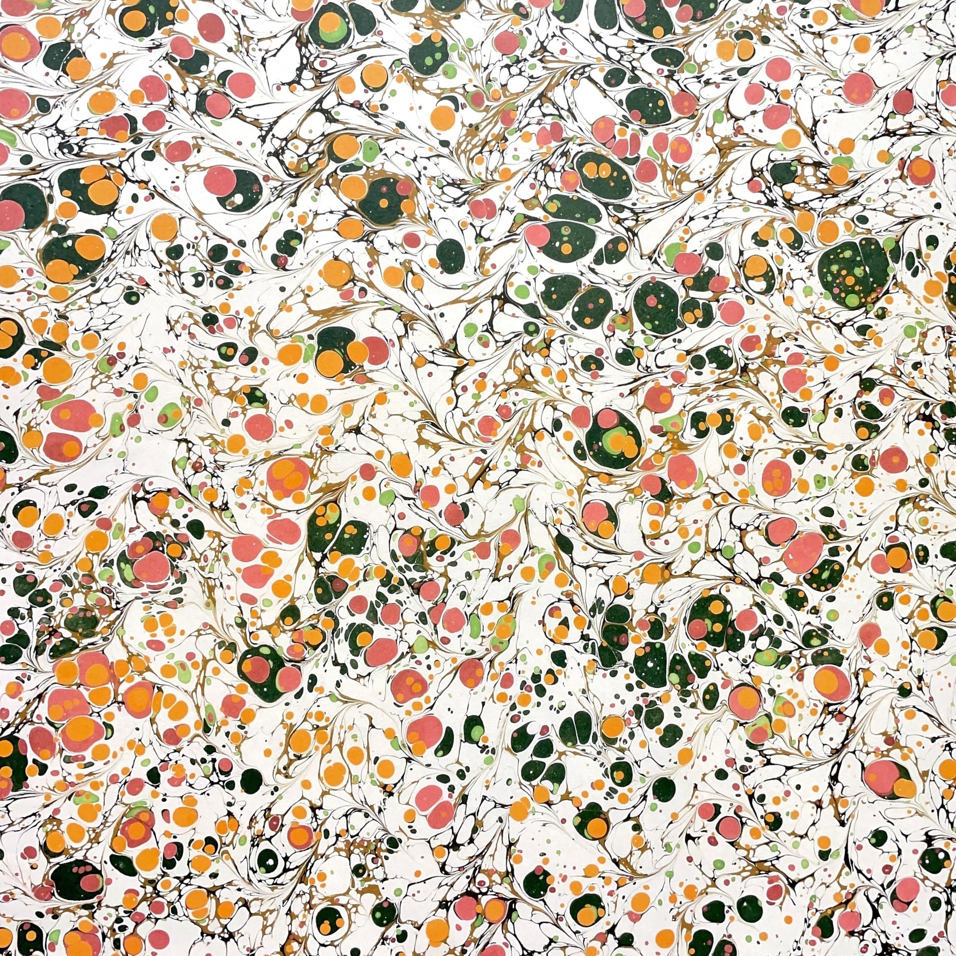 Printed marbled wrapping paper by Jemma Lewis Marbling. Marbled paper in bright yellow, pink and green on white backdrop.