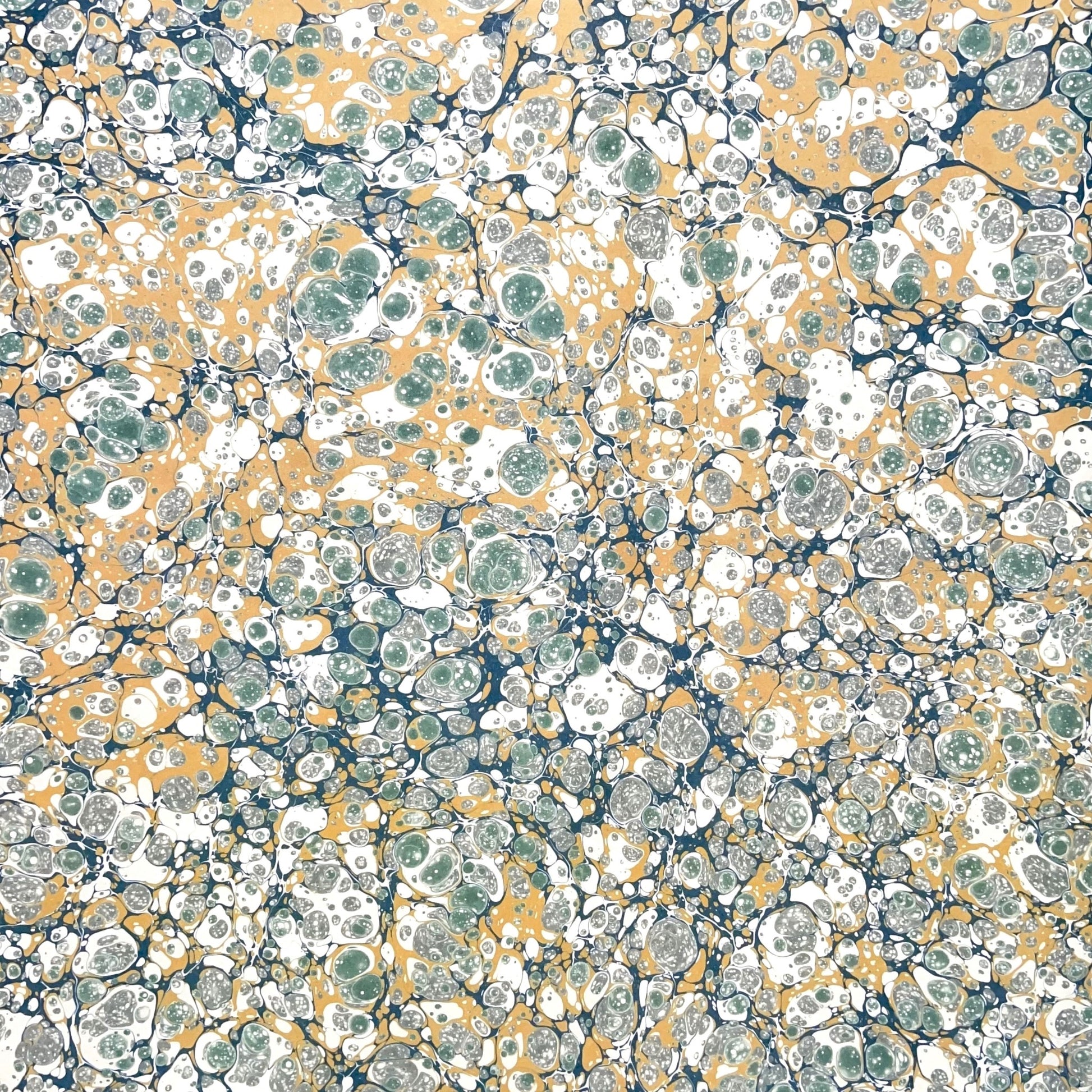 Printed marbled wrapping paper by Jemma Lewis Marbling. Marbled paper in soft greens, teal and yellow