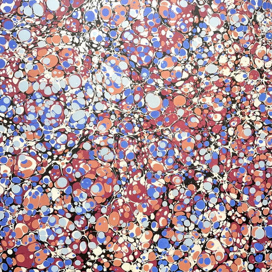 Printed marbled wrapping paper by Jemma Lewis Marbling. Marbled paper in bold red, blue and orange