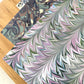 printed marbled design wrapping paper by Jemma Lewis, a feathered marble in green and lilac 