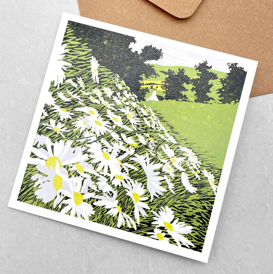 greetings card showing side of a hill covered in daisies by John Austin Publishing