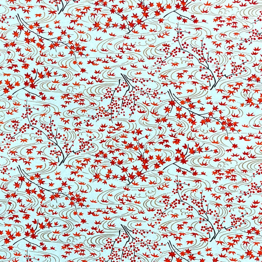 a sheet of japanese silkscreen printed chiyogami paper with a pattern of gold rivers, red falling leaves on a soft aqua background