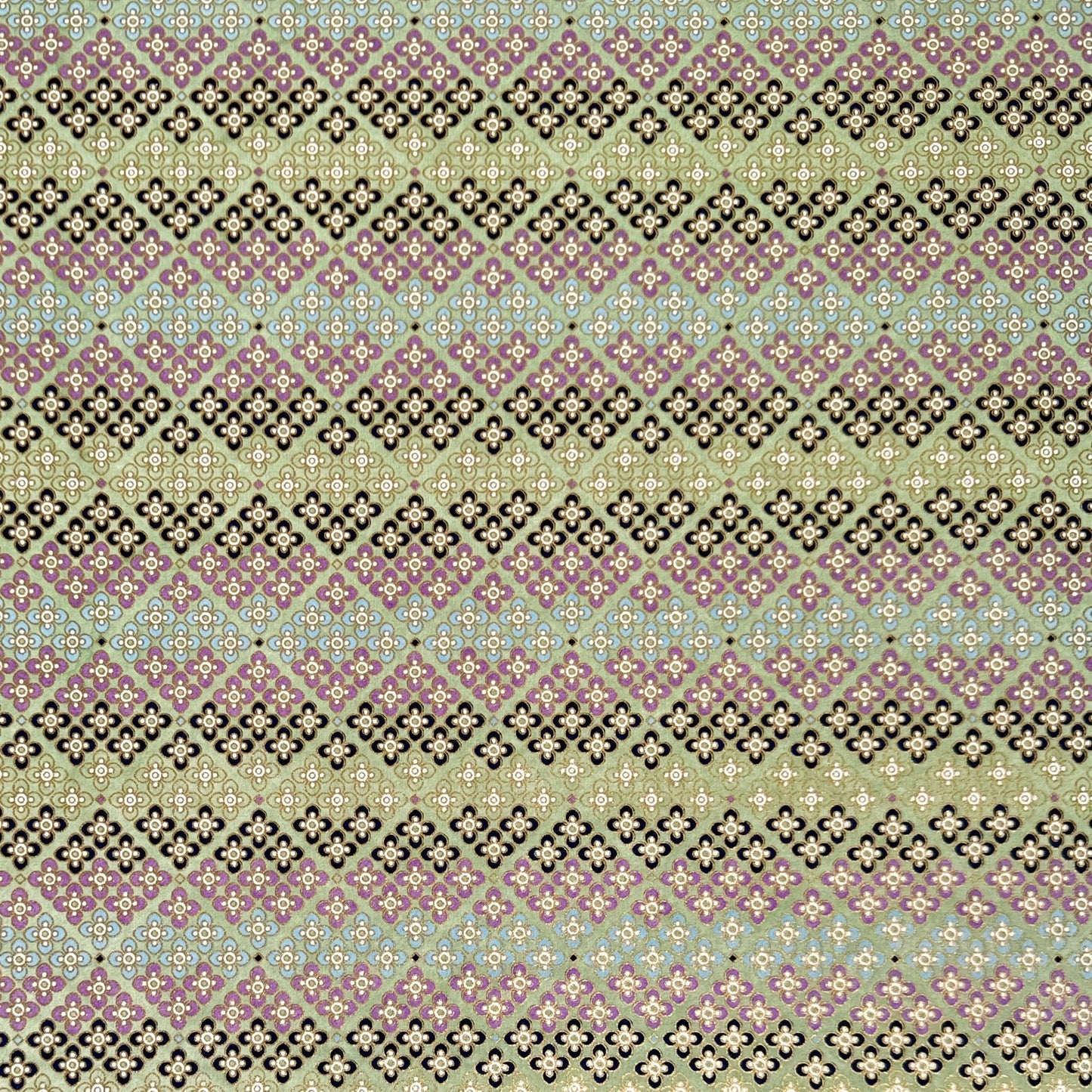 Japanese silkscreen chiyogami paper with a repeat pattern of stripes of a small floral motif in black, lilac and blue on a moss green backdrop