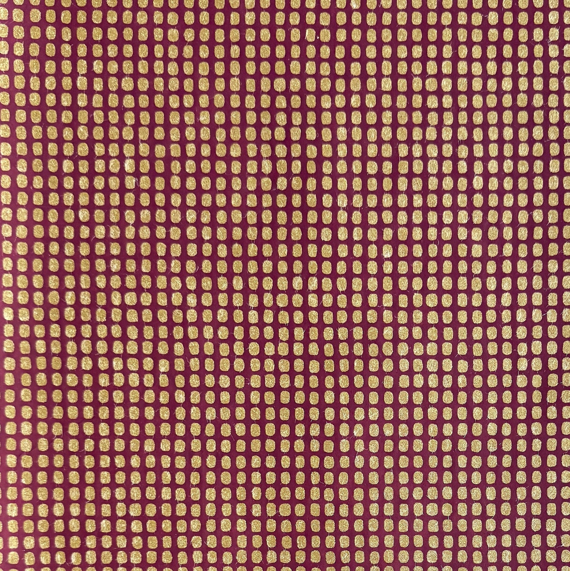 a sheet of Japanese chiyogami paper in rich claret red with a repeat pattern of gold rounded rectangles