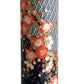 Diagonal branches of rich pink plum (ume) blossom on a midnight blue background with gold accents. Japanese chiyogami paper