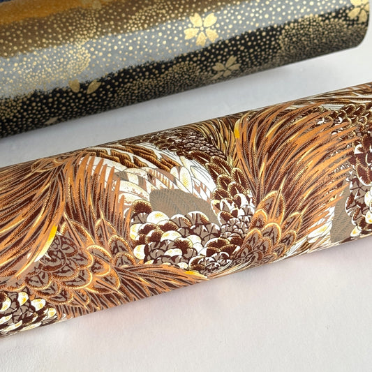Detailed pattern of the plumage of feathers in brown, beige and ochre. Japanese chiyogami paper