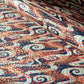 a sheet of Japanese chiyogami paper with a pattern of swirling streams with red and gold falling leaves, dark blue background