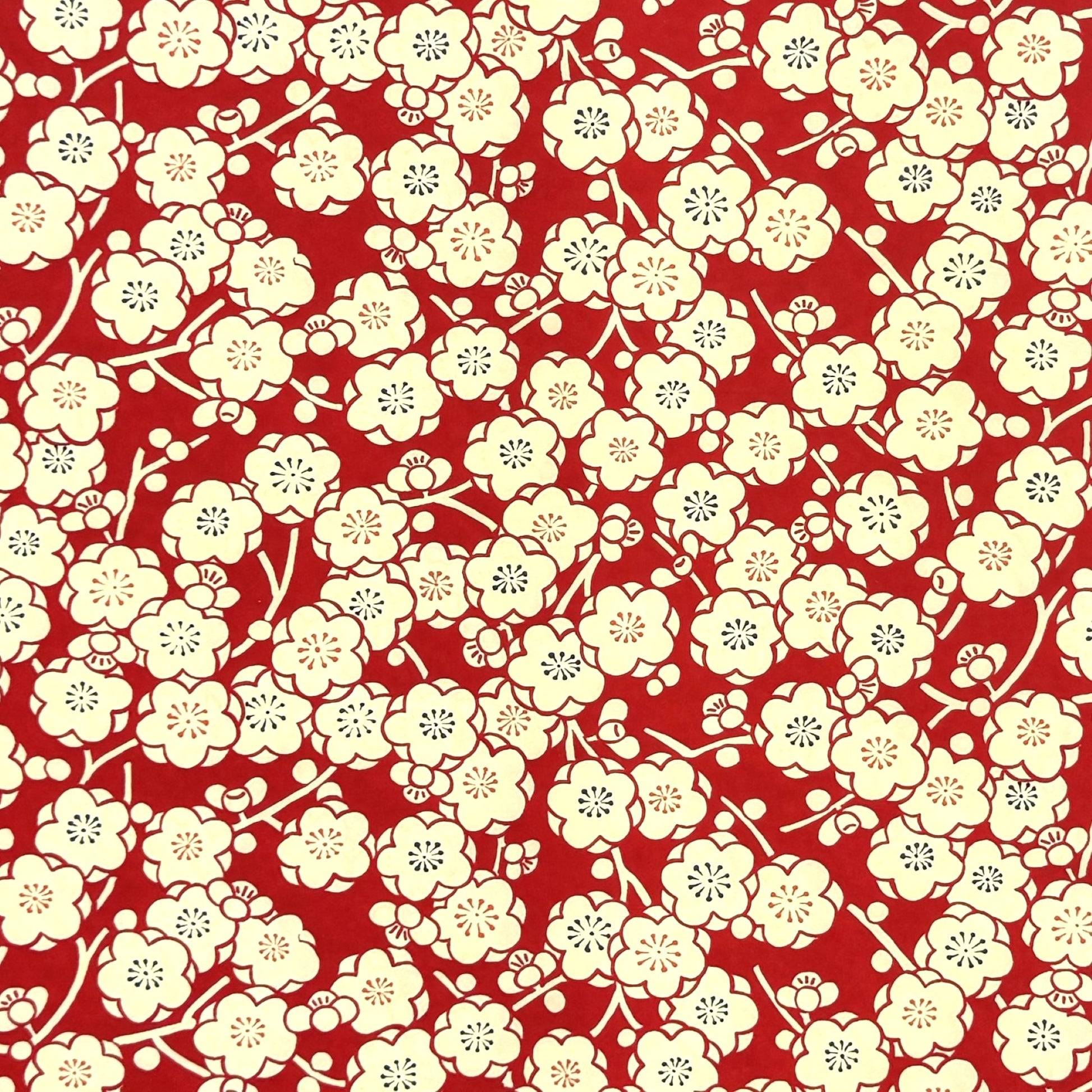 a sheet of chiyogami paper with a modern design of plum blossom in red and cream