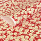 a sheet of chiyogami paper with a modern design of plum blossom in red and cream