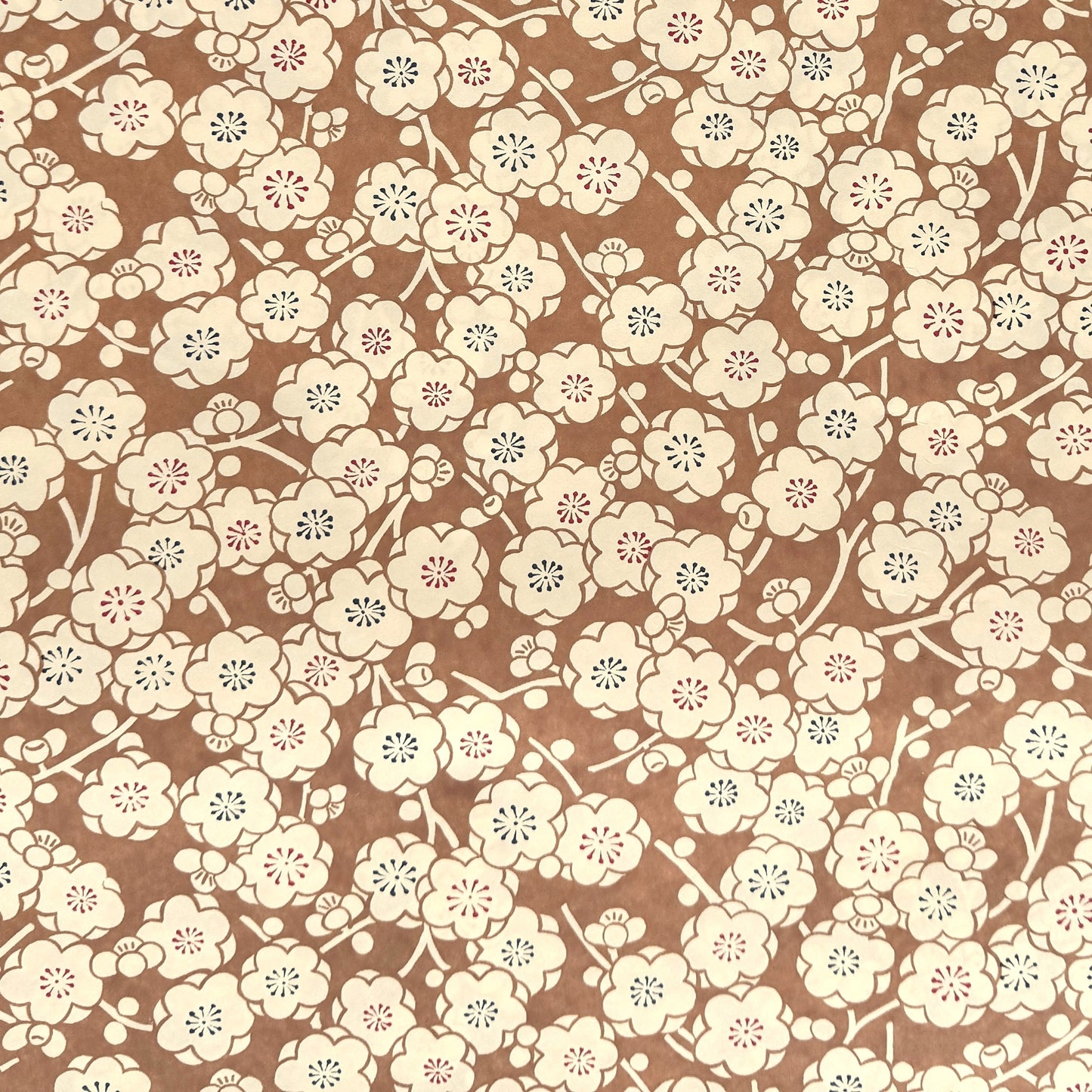 a sheet of Japanese chiyogami paper with a modern interpretation of plum blossom in taupe and cream