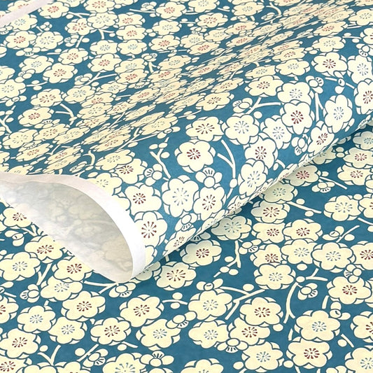 a sheet of chiyogami paper with a modern plum blossom pattern in aqua and cream
