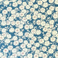 a sheet of chiyogami paper with a modern plum blossom pattern in aqua and cream