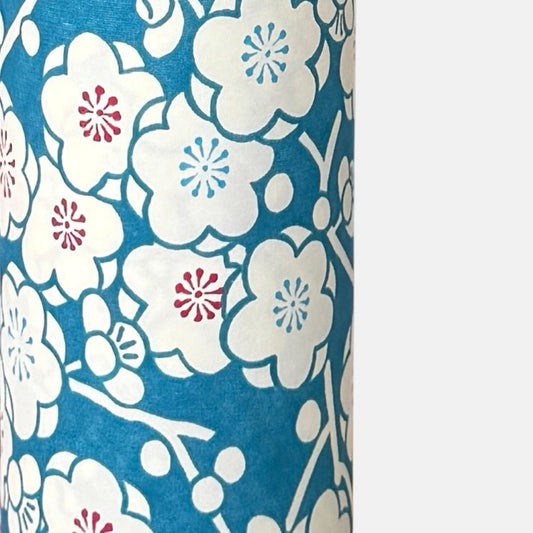 a sheet of chiyogami paper with a modern plum blossom pattern in aqua and cream