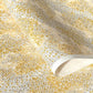 a sheet of Japanese chiyogami yuzen paper with a delicate pattern of little sakura cherry blossom in amber yellow and white