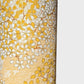 a sheet of Japanese chiyogami yuzen paper with a delicate pattern of little sakura cherry blossom in amber yellow and white