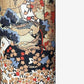A sheet of Chiyogami paper with a traditional Japanese pattern of a detailed hillside in blue, red, bronze and black. 