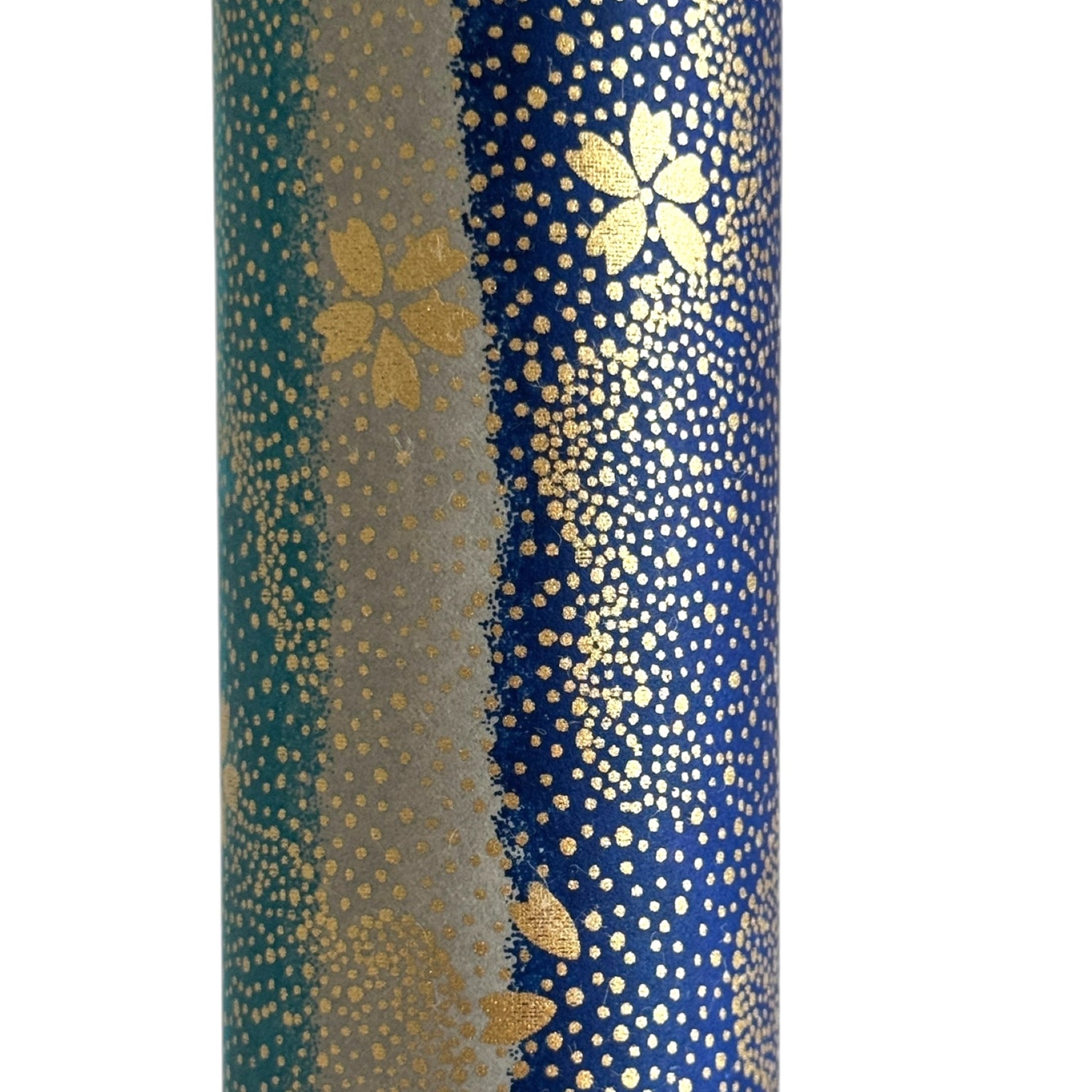 japanese chiyogami paper in stripes of blue, turquoise and grey with gold clouds and flowers. Close up