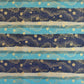 japanese chiyogami paper in stripes of blue, turquoise and grey with gold clouds and flowers
