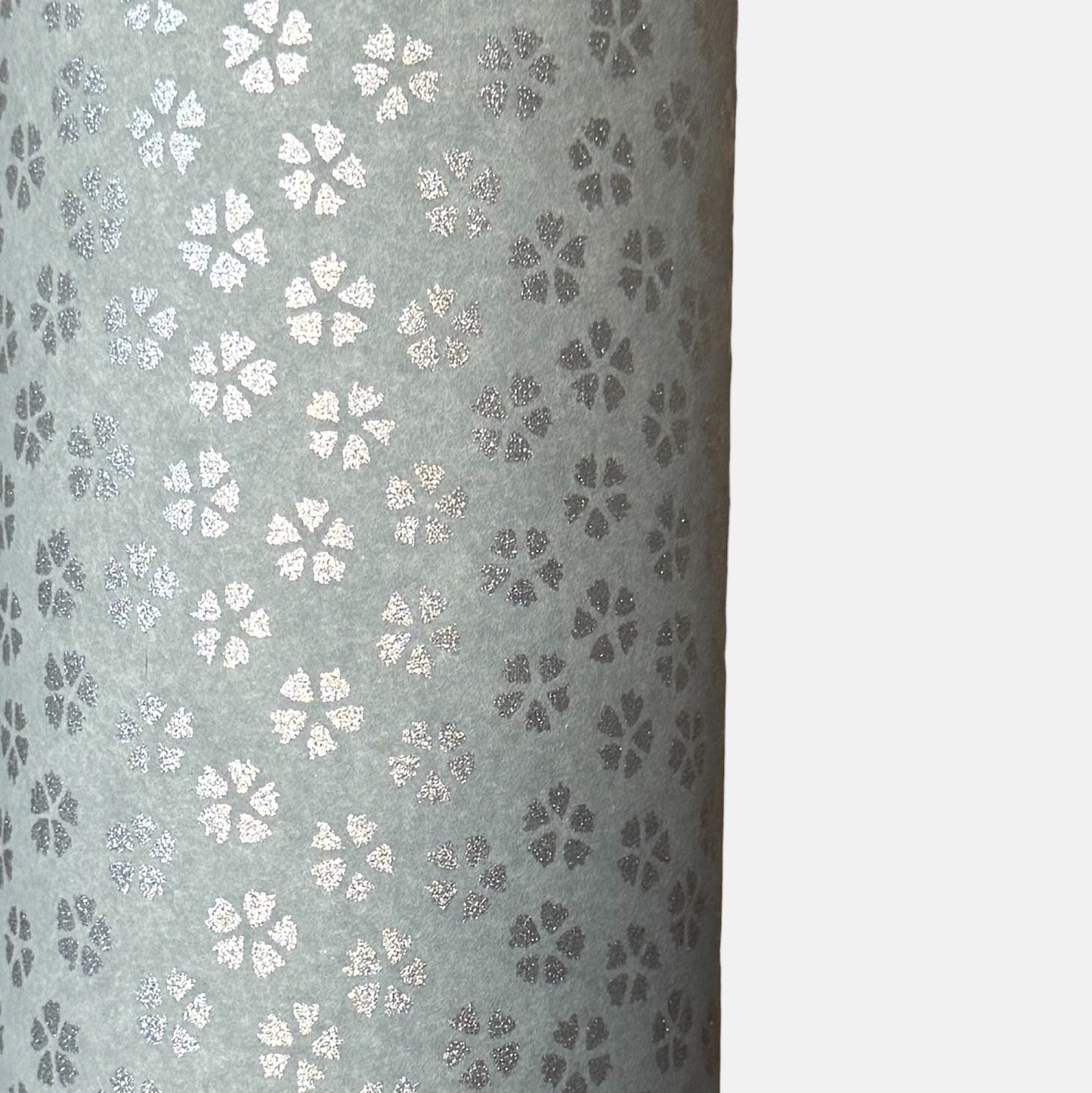 a sheet of chiyogami paper with light grey background and little silver stylised cherry blossom flowers in silver 