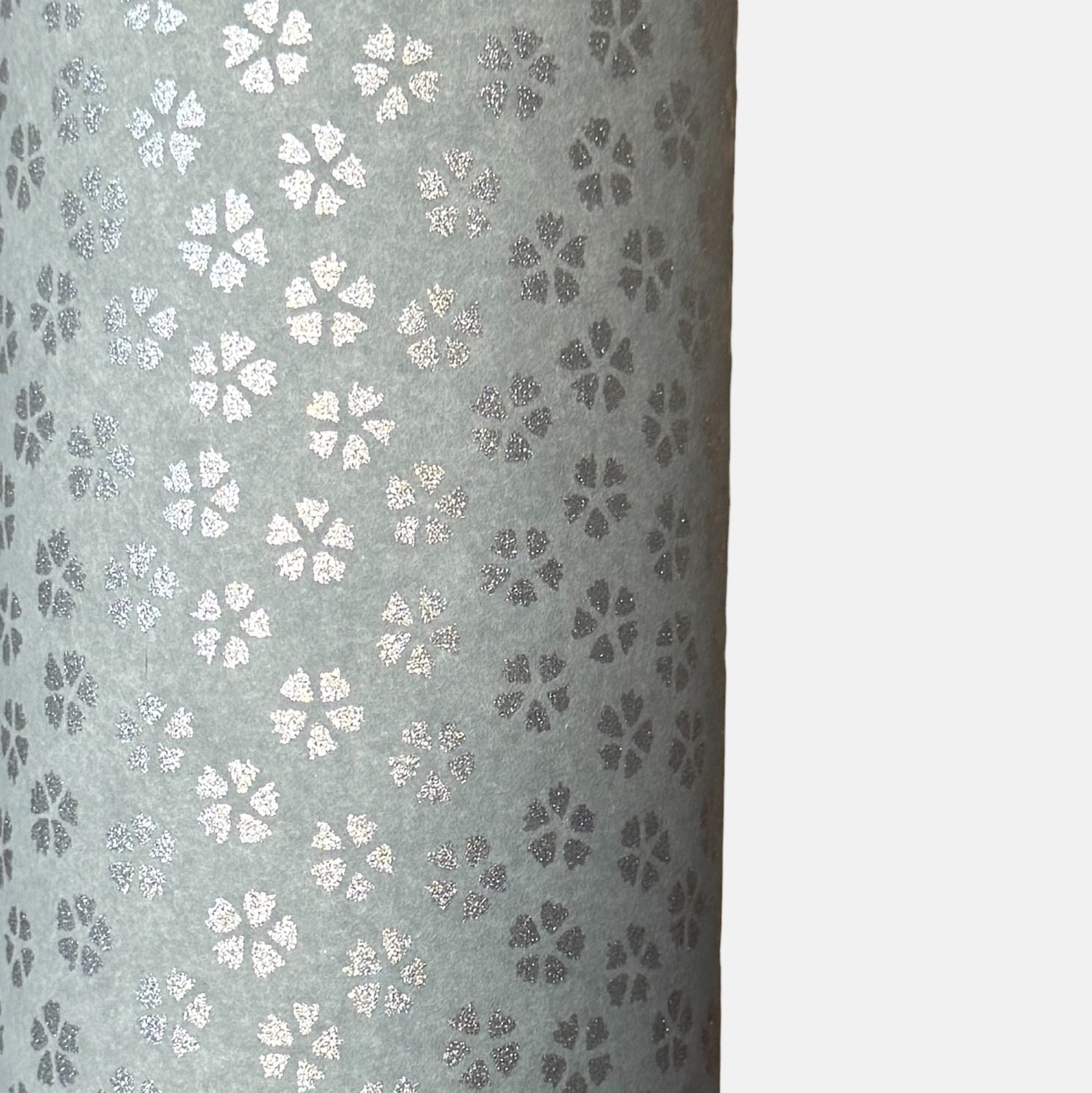 a sheet of chiyogami paper with light grey background and little silver stylised cherry blossom flowers in silver 
