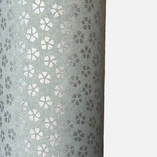 a sheet of chiyogami paper with light grey background and little silver stylised cherry blossom flowers in silver 