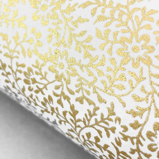 japanese silk-screen handmade paper showing a dainty gold botanical repeat design on ivory backdrop