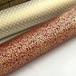 a sheet of Japanese chiyogami yuzen paper with a ditsy gold floral design on a deep red