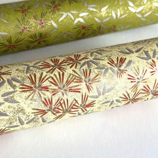 Pattern of scattered pine needles (matsuba) in gold and silver on a cream backdrop. Japanese chiyogami paper. CLose up