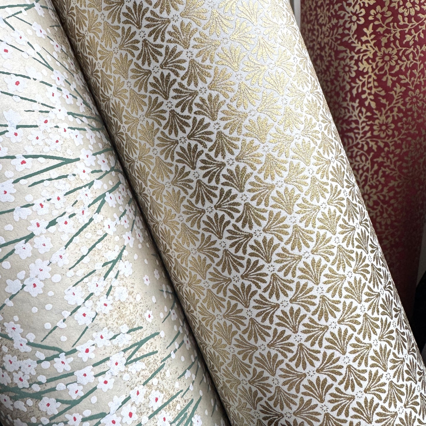 a sheet of Japanese silkscreen printed chiyogami yuzen paper with a micro gold geometric pattern on white backdrop