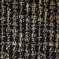 a sheet of Japanese chiyogami paper with gold Japanese kanji text on black background