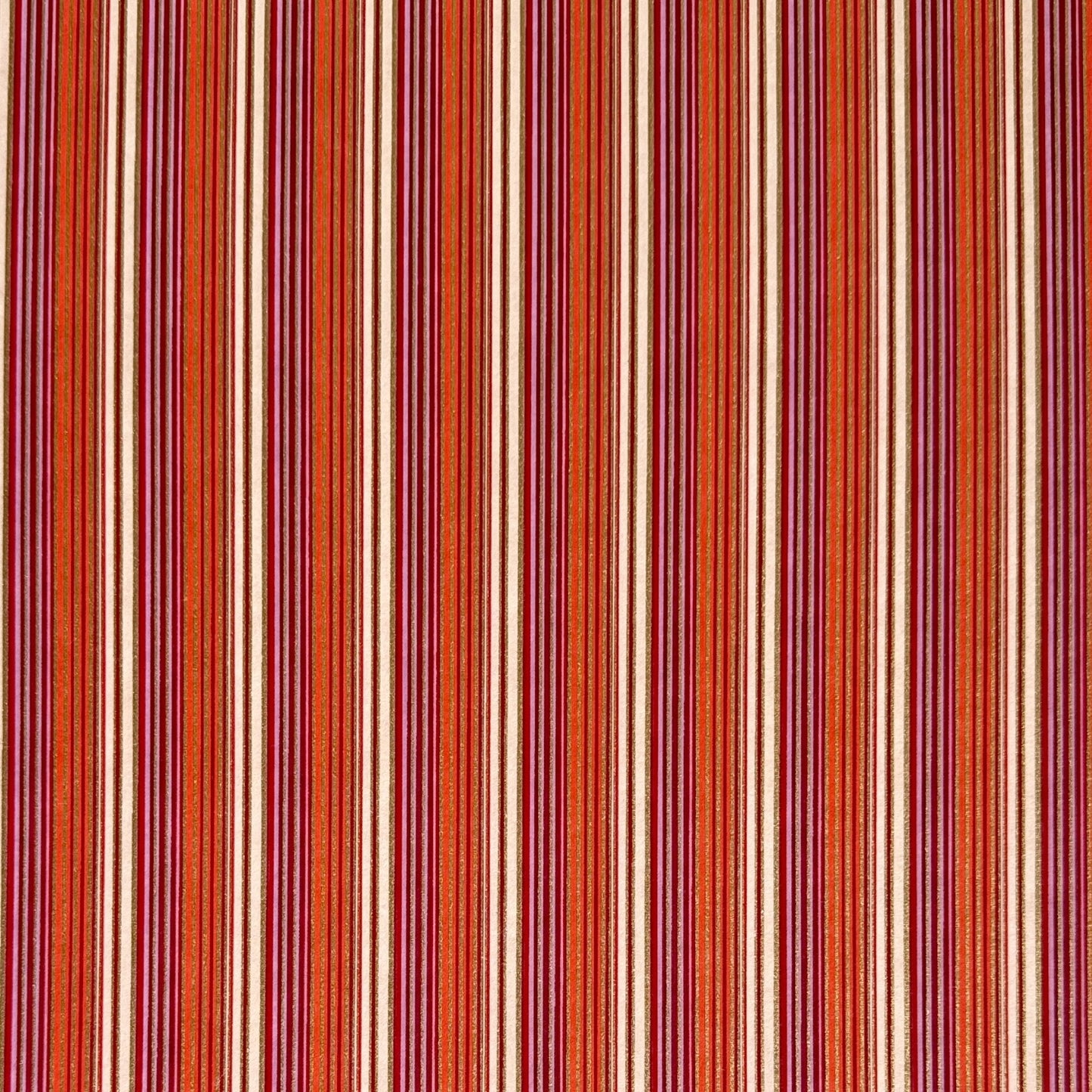 Japanese silkscreen chiyogami paper with a classic narrow stripe pattern in berry tones of red, pink, purple and gold.