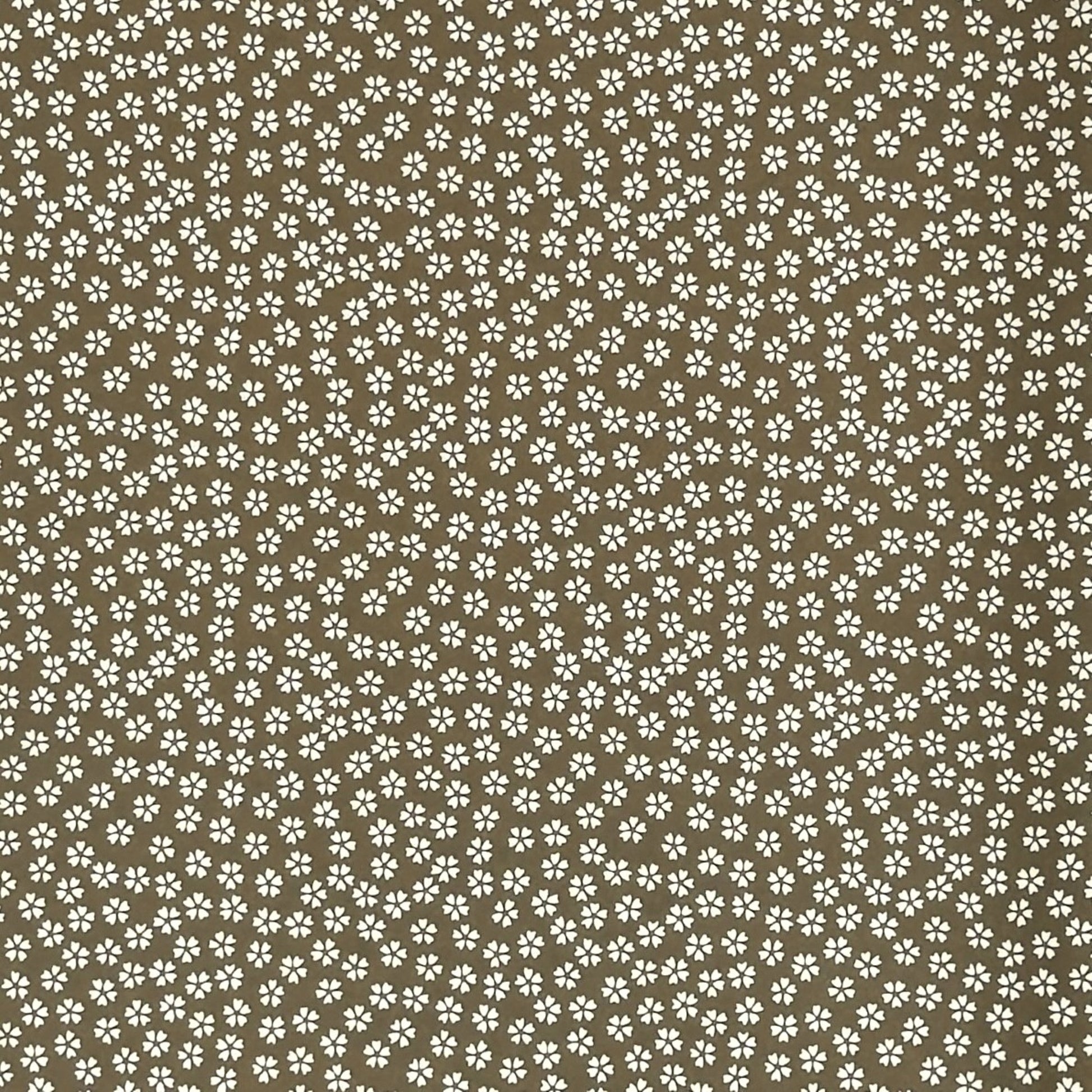 a sheet of chiyogami paper with a mocha brown background and little white stylised cherry blossom flowers