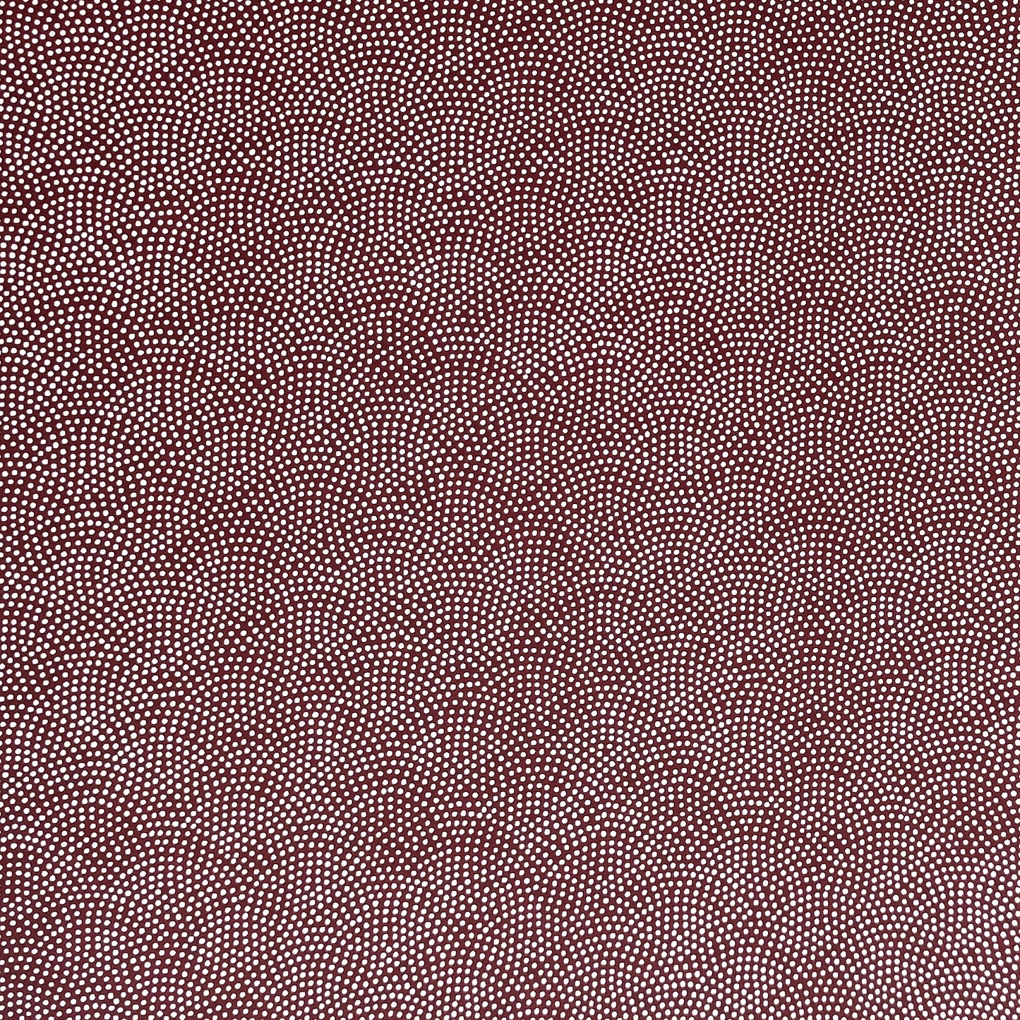 a sheet of Japanese chiyogami paper with an aubergine background and a small repeat pattern of tiny white dots in an arch shape