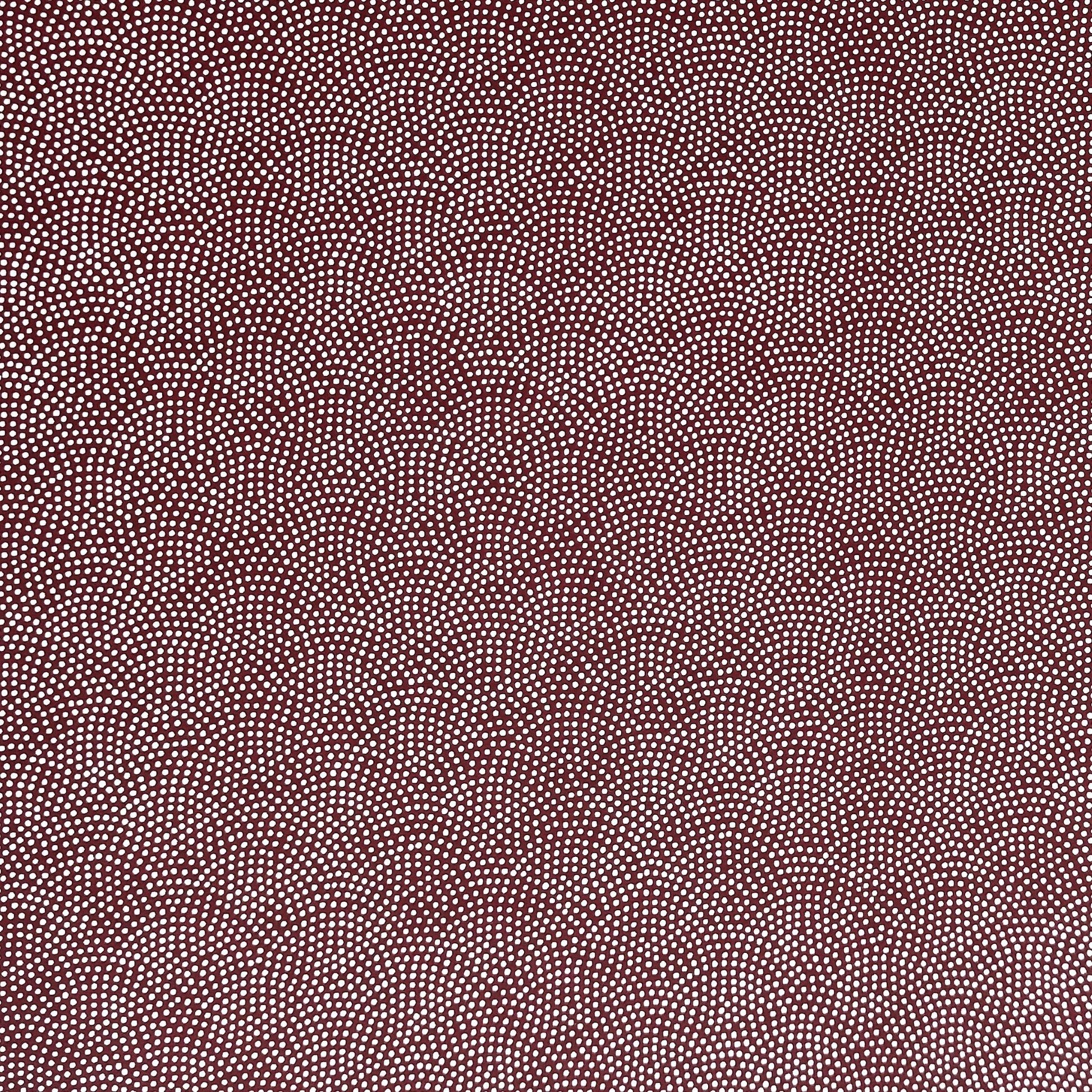 a sheet of Japanese chiyogami paper with an aubergine background and a small repeat pattern of tiny white dots in an arch shape