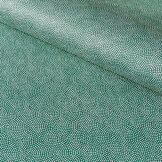 a sheet of Japanese chiyogami paper with a forest green background and a small repeat pattern of tiny white dots in an arch shape