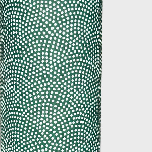 a sheet of Japanese chiyogami paper with a forest green background and a small repeat pattern of tiny white dots in an arch shape