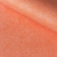 a sheet of chiyogami with a coral orange background and an small dotted arch pattern
