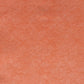 a sheet of chiyogami with a coral orange background and an small dotted arch pattern