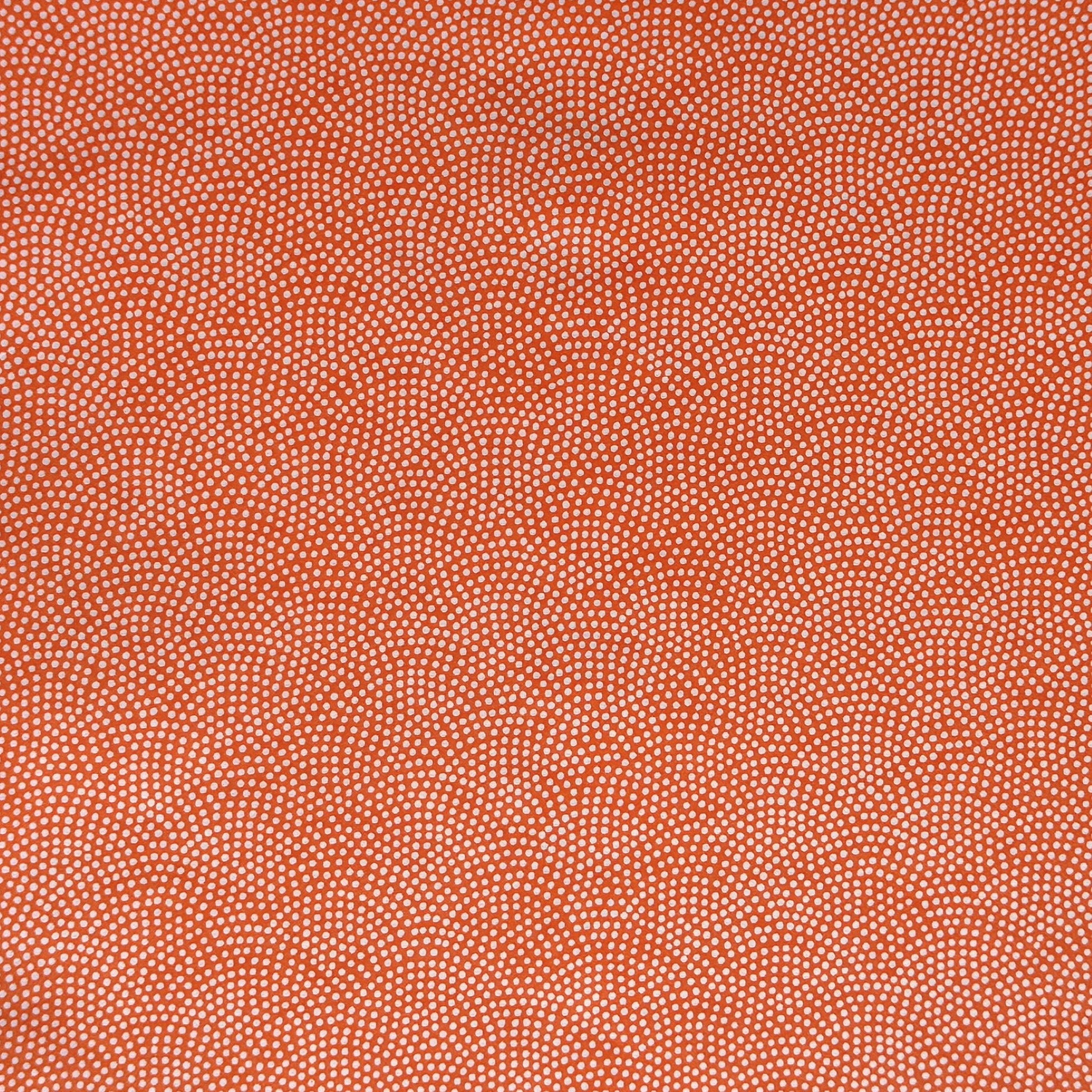 a sheet of chiyogami with a coral orange background and an small dotted arch pattern