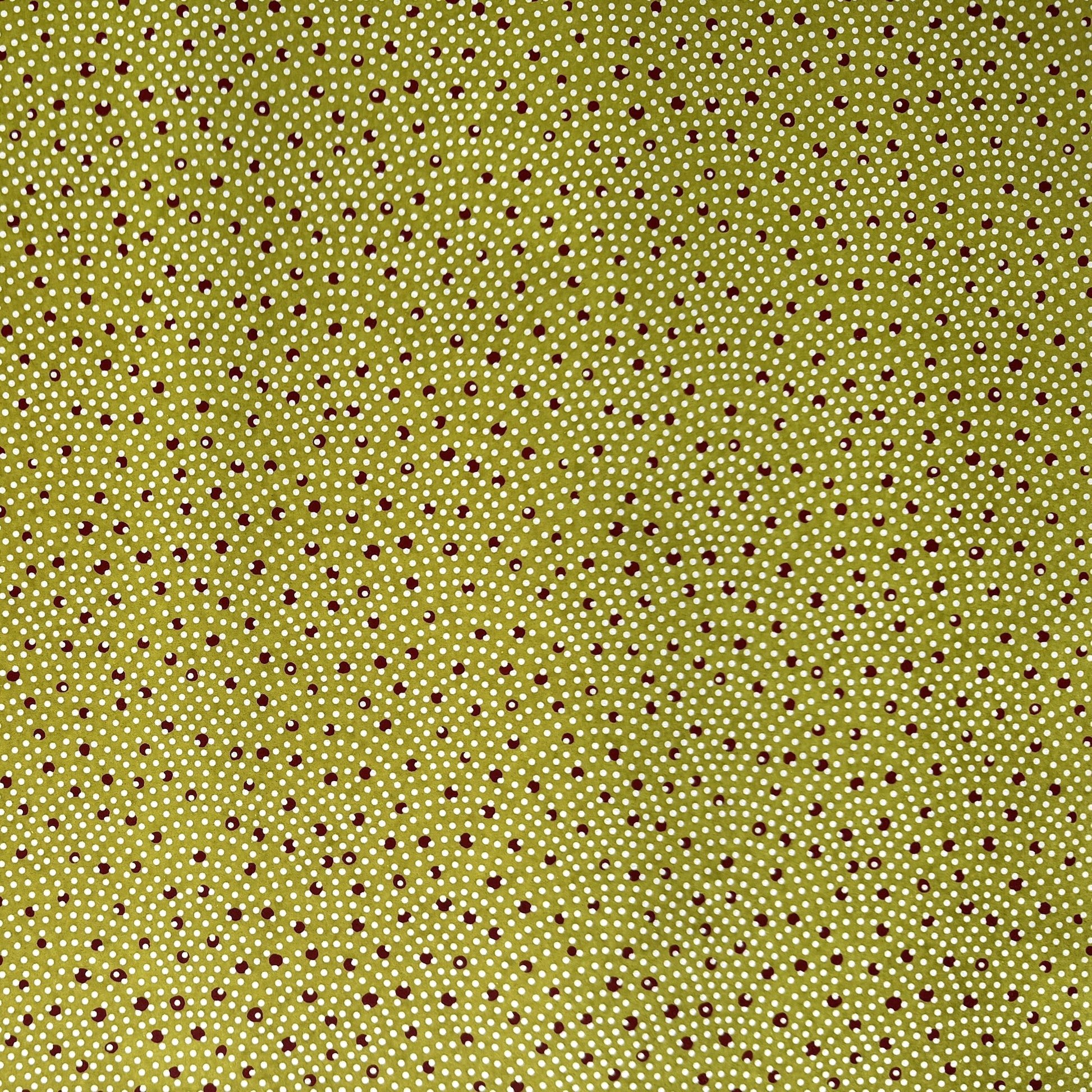 a sheet of Japanese chiyogami paper with an olive backdrop and a white dotted repeat arch pattern with red dots