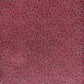 a sheet of Japanese chiyogami paper with an aubergine backdrop and a white dotted repeat arch pattern with black dots