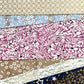 a sheet of Japanese silkscreen printed chiyogami yuzen paper with a micro floral pattern in aubergine, white and black.