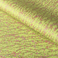 a sheet of chiyogami paper with a lime green background and vertical pattern of little plum flower trails in pink and gold