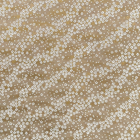 a sheet of Japanese silkscreen printed chiyogami paper with waves of tiny white and gold flowers on a soft taupe background with a dusting of gold.