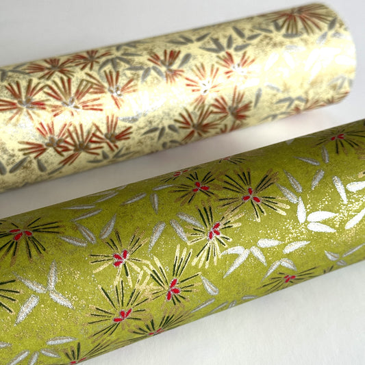 Pattern of scattered pine needles (matsuba) in gold and silver on an olive backdrop.  Japanese chiyogami paper. Rolled