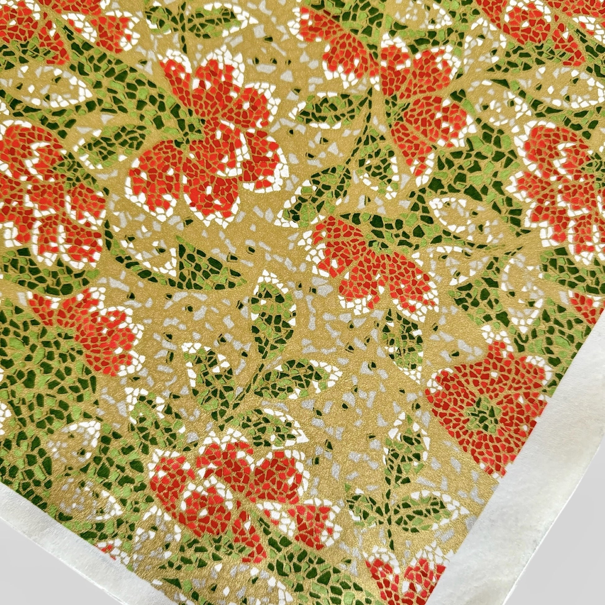 Japanese silkscreen chiyogami paper with a mosaic pattern of scarlet chrysanthemums on gold with green foliage.